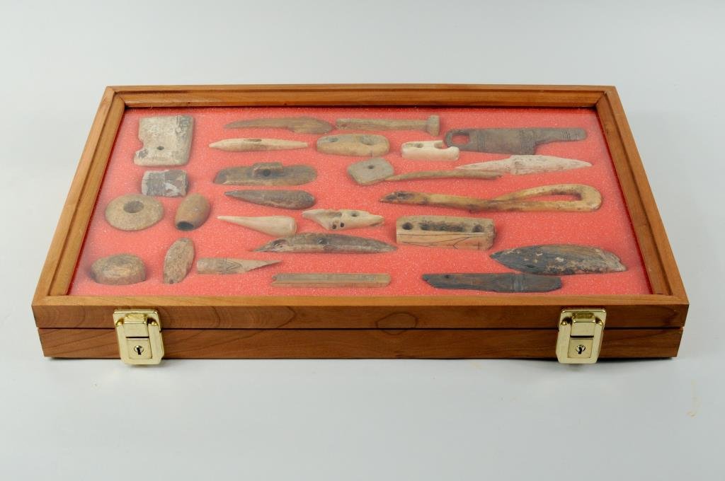Inuit/Thule/Dorset Tool Collection: Twenty-six early Inuit, Thule and Dorset ivory and bone tools, some with incised decoration including a net float, bolo weight, ivory fid, net needles, harpoon parts, labret, fish hook and other artif