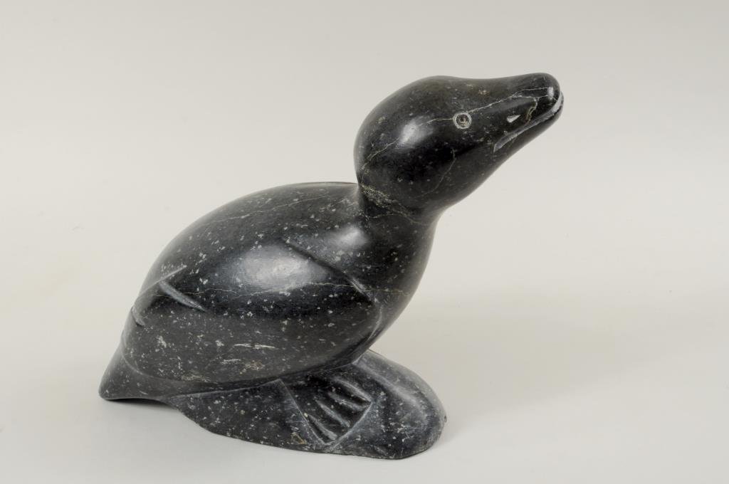 Large Inuit Stone Carving Of Bird: Large Inuit stone carving of bird with tag on base stating carver Levi. 9" high, 10 1/2" long. Condition: scratches.