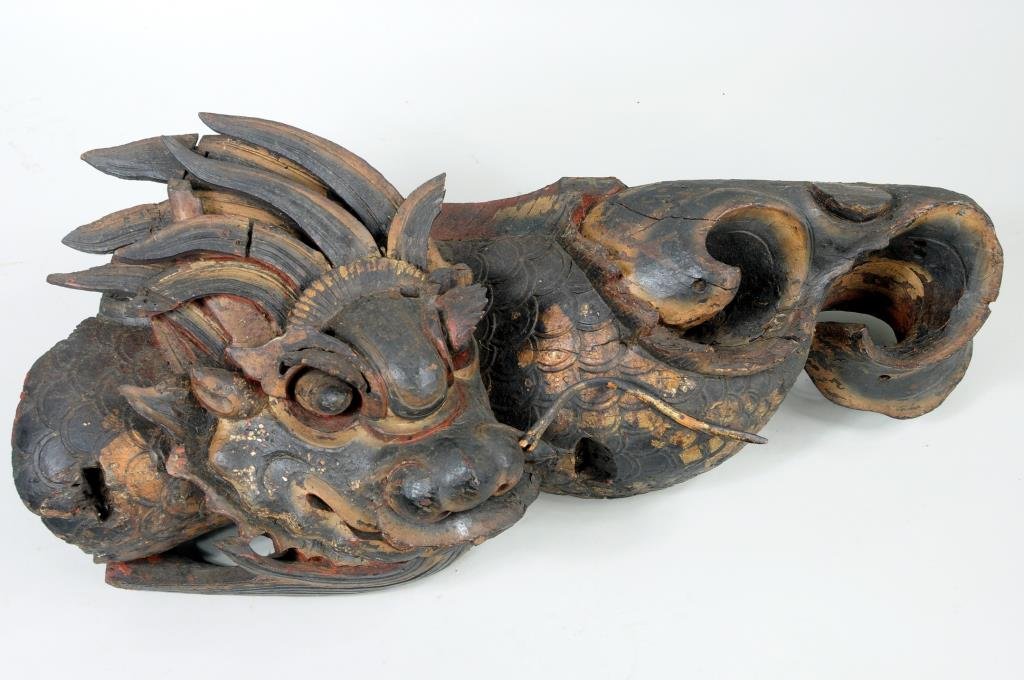 Asian Carved Wood Parcel Gilt Dragon Ornament: Large Asian carved wood parcel gilt dragon architectural ornament. 9" high, 32" long. Condition: wear from exposure to elements, paint, gilt wear, loss, age cracks, cracks, losses.