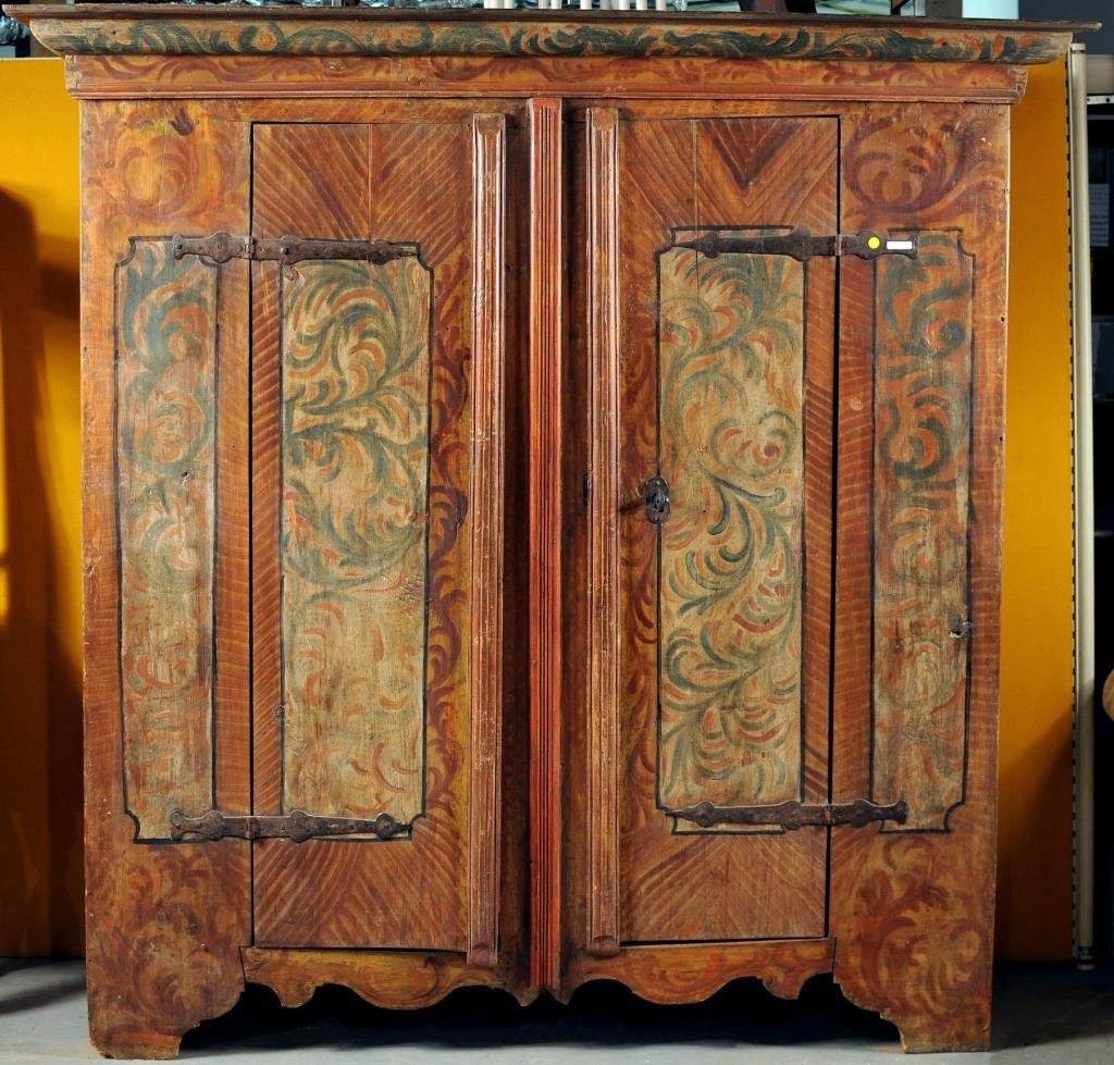 Continental Painted Kas: Continental painted Kas with molded cornice, iron strap hinges on cutout base. 78 1/2" high, 65 1/2" wide. Condition: worm damage, repairs, small losses, repainting.