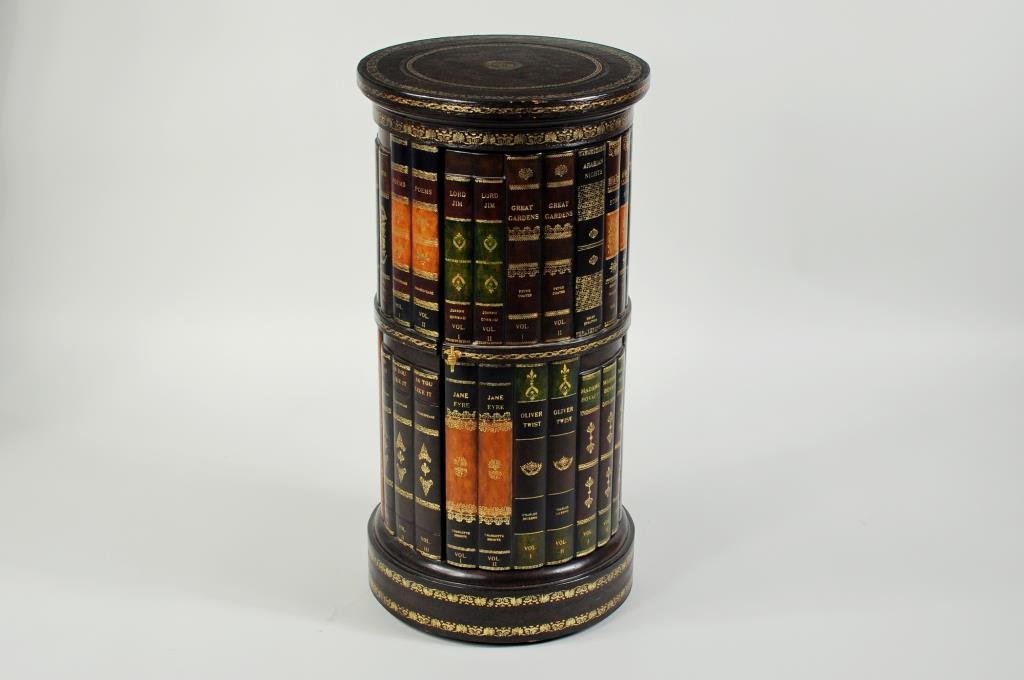 Maitland-Smith Circular Faux Book Cabinet: Maitland Smith faux book cabinet, of circular form with green & gilt leather top, labeled underside. 28" high, 14" deep.