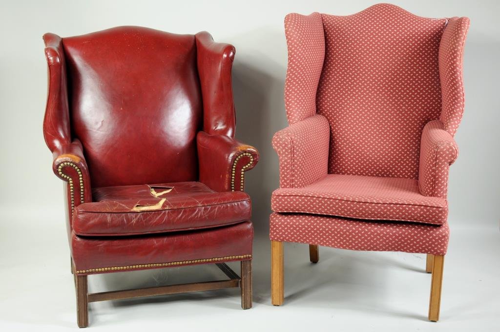 Two Chippendale Style Wing Chairs: Chippendale style wing chair, fine replica chair having molded front legs. 49" high, 30" wide, 24" deep, together with a second mahogany molded leg example, in distressed red leather upholstery.