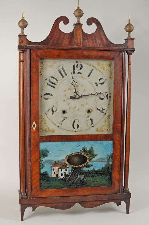 Mahogany Veneered Pillar & Scroll Clock: Mahogany veneered pillar & scroll clock circa 1820 by Chauncey Ives (1787-1857), active 1811-1838, with label. 31 1/2" high, 16 1/2" wide. Condition: replaced finial tops, dial with paint wear, loss,