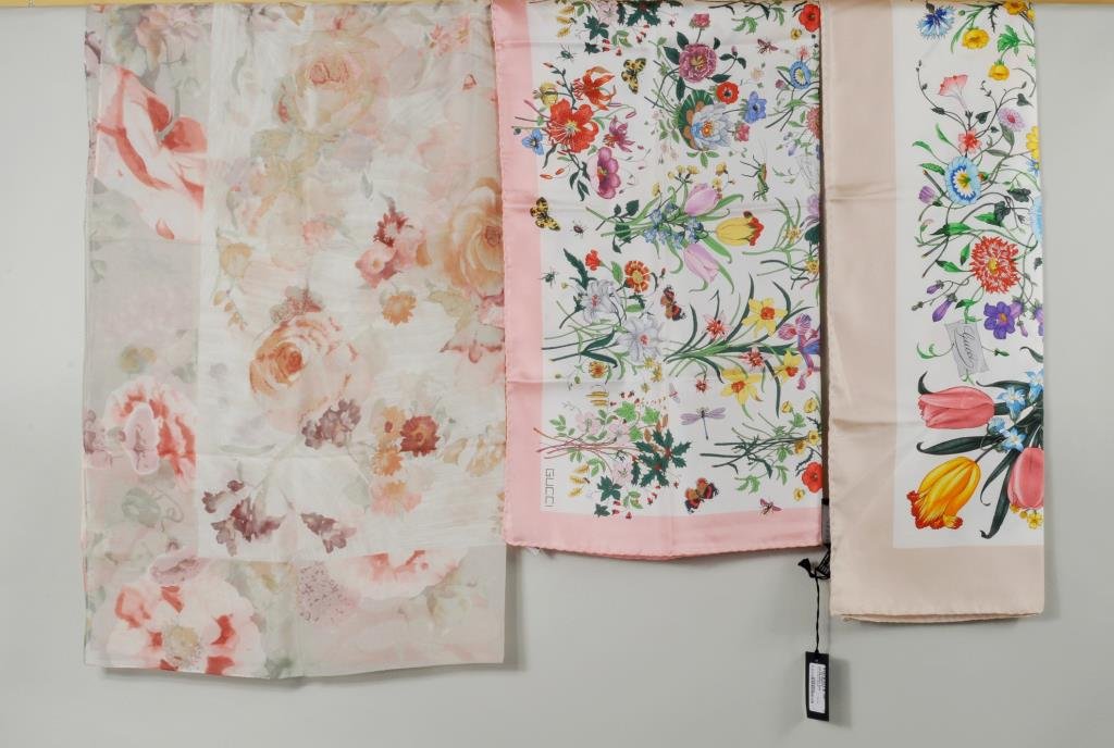 Group Three Scarves, Gucci & Ralph Lauren: Three floral scarves comprising two Gucci and a Ralph Lauren scarf. 26" long, 26" wide to 34" long, 34" wide. Condition: large Gucci and Ralph Lauren unused.