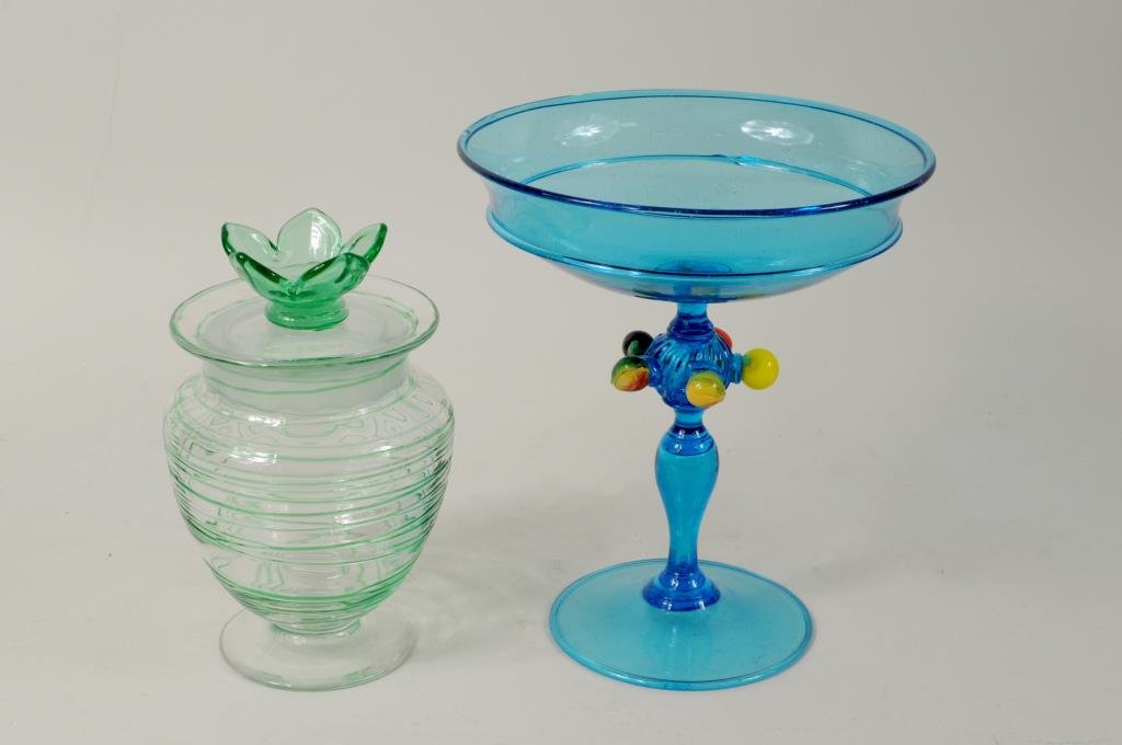 Steuben Threaded Jar & Venetian Compote: Two art glass items comprising a Steuben green threaded jar with floral lid, acid etched fleur de lis stamp on base, and a blue Venetian compote with applied fruit decoration, unsigned. Condition: jar