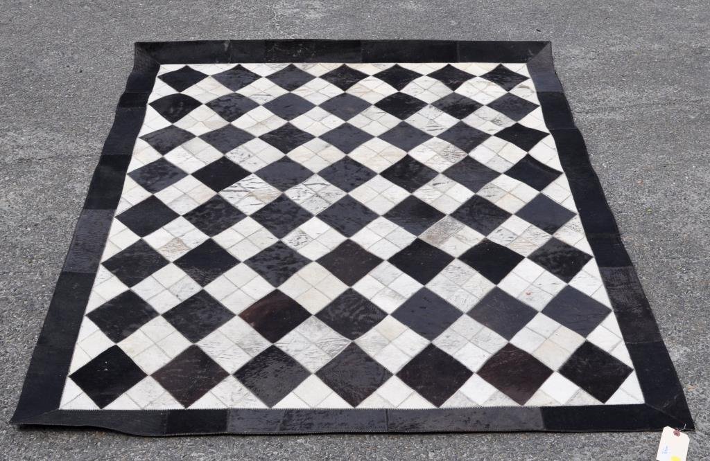 Modernist Cow Hide Geometric Pattern Floor Mat: Modern cow hide geometric pattern floor mat. 75" high, 51" wide. Condition: hide wear, loss, stains.