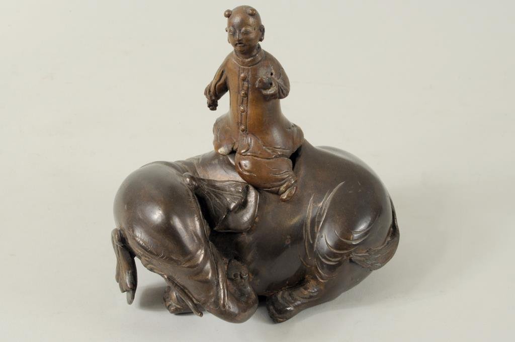 Chinese Two Part Bronze Container: Chinese two part bronze container in the form of a young boy astride an elephant, unsigned. 6 1/2" high, 6 1/2" wide. Condition: casting defects.