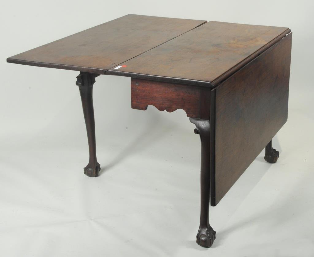 American Chippendale Drop Leaf Table, B/C Feet: American Chippendale mahogany drop leaf table on ball and claw feet. 42" long, 19 1/4" wide, 27 3/4" high. Open: 42" long, 54" wide, 27 3/4" high. Condition: finish wear, loss, scratches, stains, marr