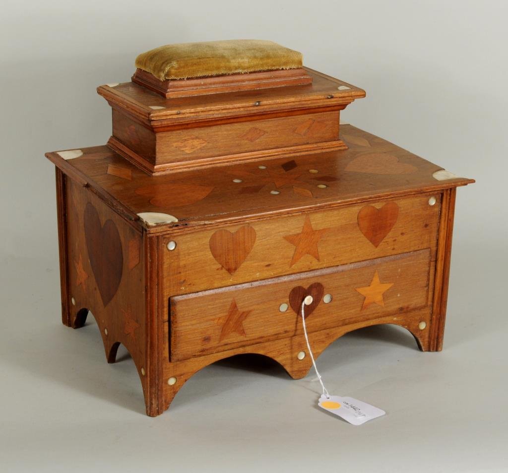 Folk Art Inlaid Sewing Box, Heart & Star Motif: Folk Art inlaid sewing box with heart, star and diamond inlay, lift up top and working drawer with pin cushion surmount, 12" high, 14" wide, 10" deep. Condition: wear, losses, some parts missing or de