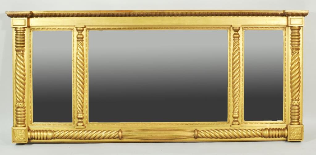 Classical Carved & Gilded Overmantel Mirror: Fine classical carved and gilded three panel overmantel mirror,with egg and dart carved upper cornice, spiral carved split column appliques separating the three mirror panels with ring turned and spir