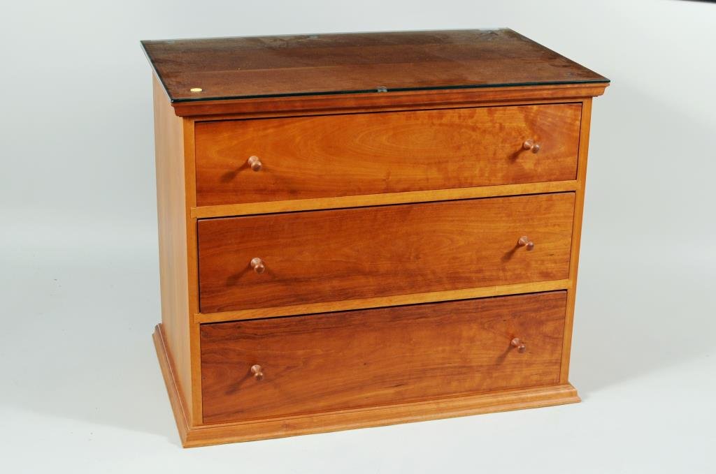Thomas Moser Shaker Style Three Drawer Chest: Thomas Moser Shaker style cherrywood three drawer chest with glass top, signed on base "Thos Moser Cabinetmakers Auburn, Maine 1987 Daniel Levasseur". 26" high, 31" wide, 19 3/4" deep.
