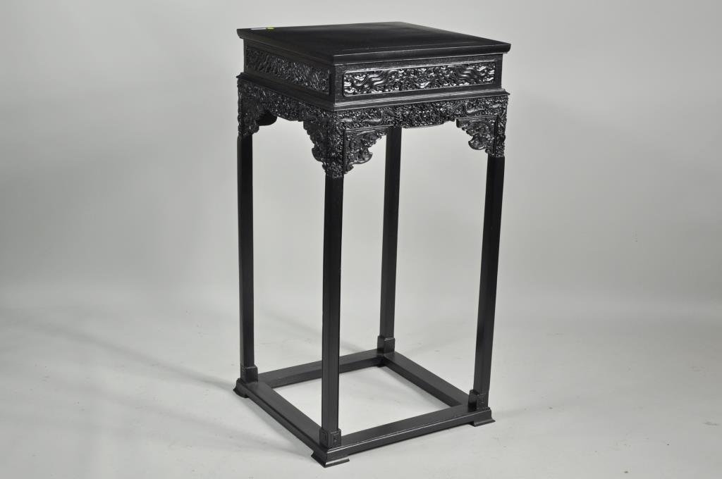 Chinese Intricately Carved & Ebonized Urn Stand: Chinese intricately carved and ebonized mixed woods urn stand with bat frieze, dragon and pearl apron. 43 3/4" high, 21 1/2" wide, 21 1/2" deep.