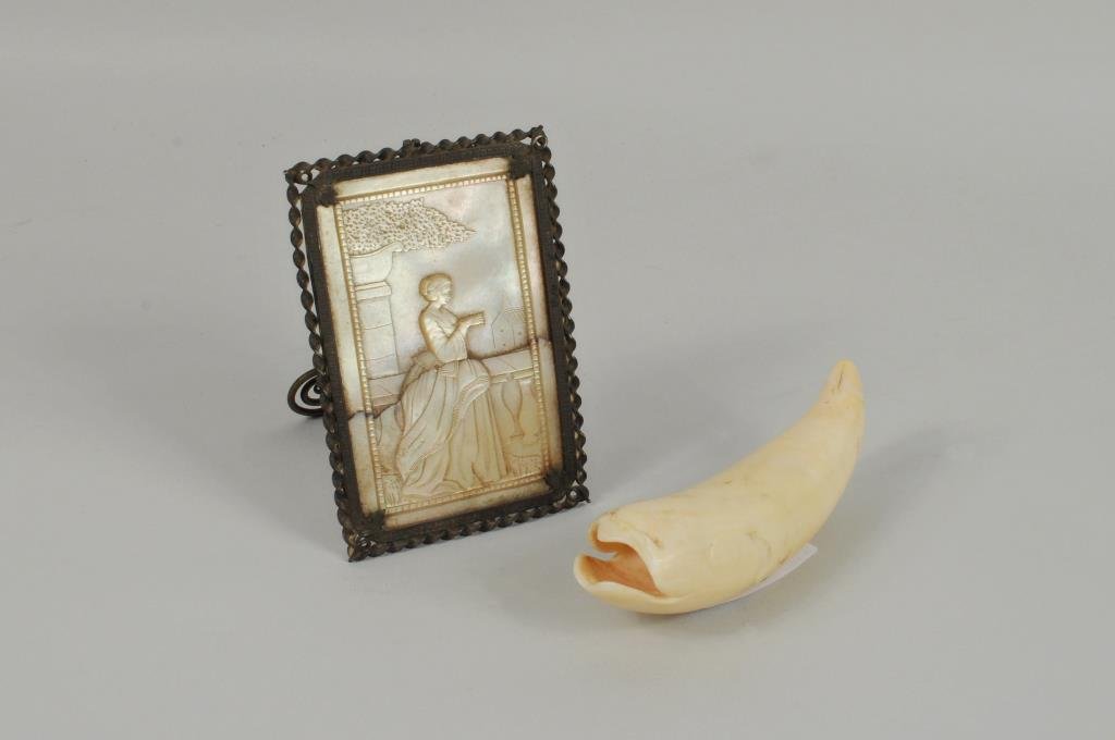 Inuit Fish Form Tooth, Mother of Pearl Plaque: An Inuit carved fish form tooth and a mother of pearl plaque. Condition: plaque cracked.