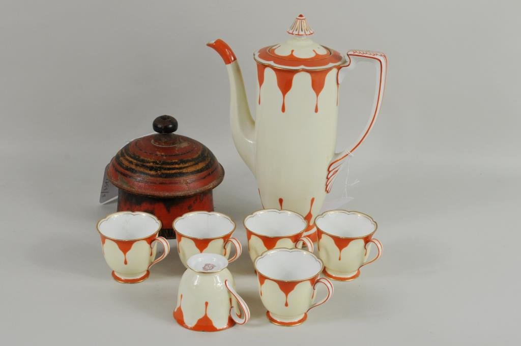 Noritake Coffee Pot & Indian Wood Container: Noritake porcelain coffee pot, six cups and an Indian turned wood container. 2 1/4" high, 3 1/4" wide to 10 1/2" high, 8" wide. Condition: chip to one cup, paint loss to container.