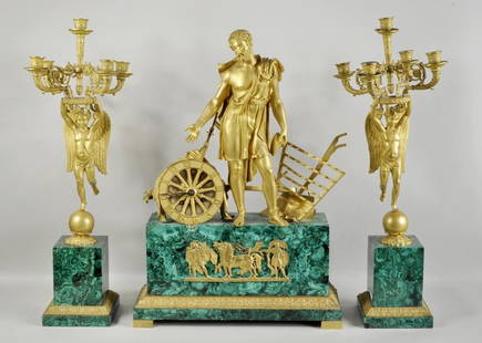 Malachite & Bronze Three Piece Clock Garniture: French Empire gilt bronze and malachite three piece clock garniture, the central figure depicting time flanked by a pair of angel five-light candelabra. 27 1/4" high, 19" wide to 27 1/2" high, 9"