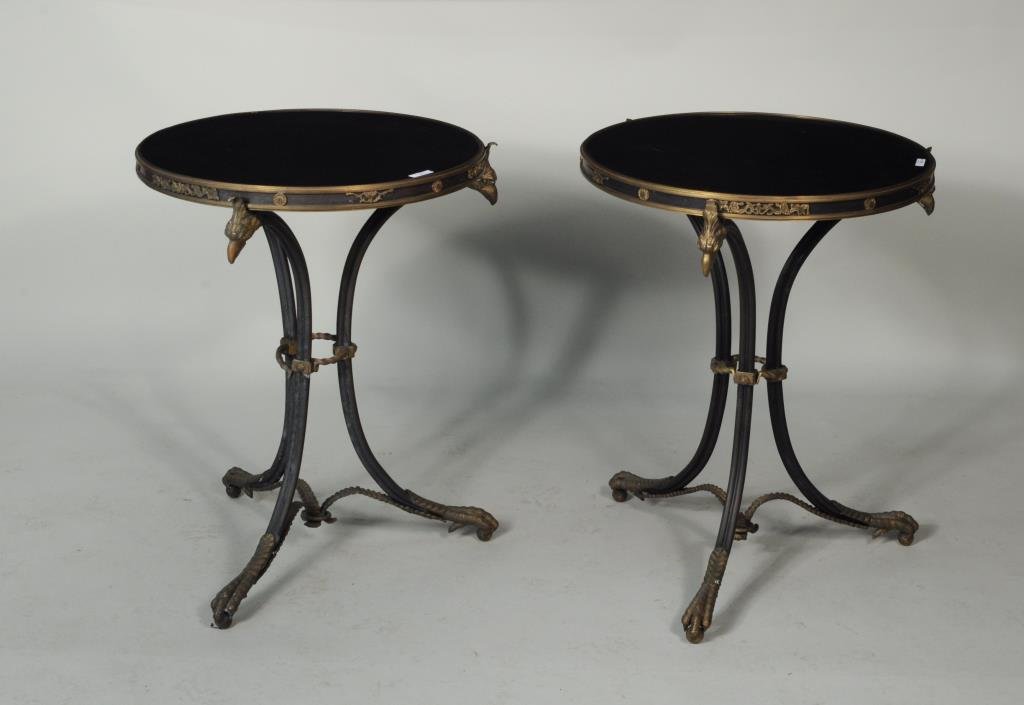 Pair Neoclassical Style Brass Mounted Tables: Pair of Neoclassical style brass mounted tables with black stone tops. 28" high, 21 3/4" diameter to 28 1/4" high, 21 3/4" diameter. Condition: one base lacking one decorative brass mount, one partial