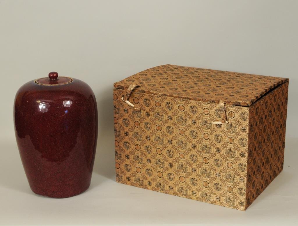 Chinese Sang De Boeuf Glazed Covered Jar: Chinese sang De boeuf glazed covered jar of tapering form, Chien Lung period 1736-1795, in custom box. 12 1/2" high, 7 3/4" wide. Condition: lid with chips to inner rim, rough base.