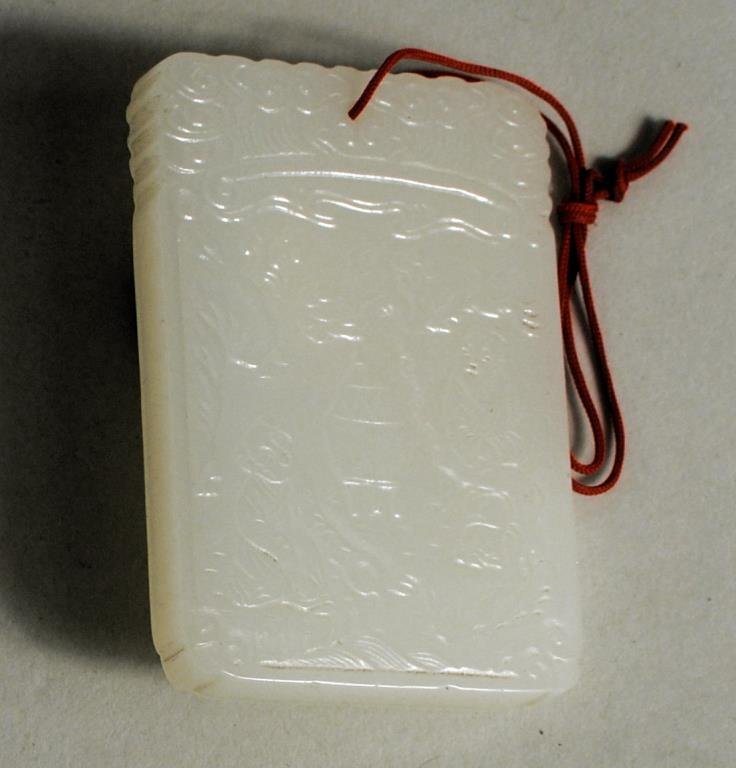 Chinese Carved White Jade Pendant Plaque: Chinese carved white jade pendant plaque depicting two figures in a landscape, inscription on verso. 2 1/2" high, 1 3/4" wide.