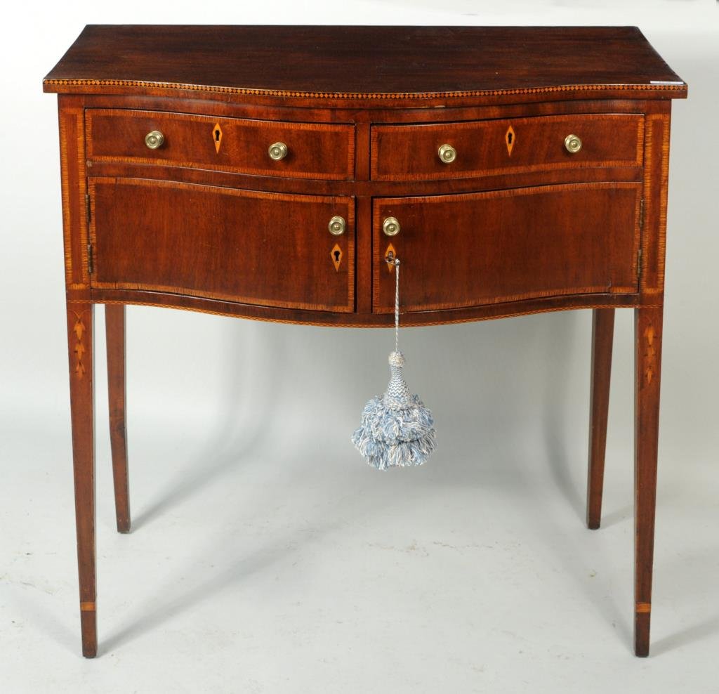 Centennial Hepplewhite Inlaid Mahogany Server: Hepplewhite style serpentine inlaid mahogany server, in the Maryland tradition, with bellflower inlays. 34 1/2" high, 35 1/4" wide, 18 3/4" deep. Condition: wear, some losses.