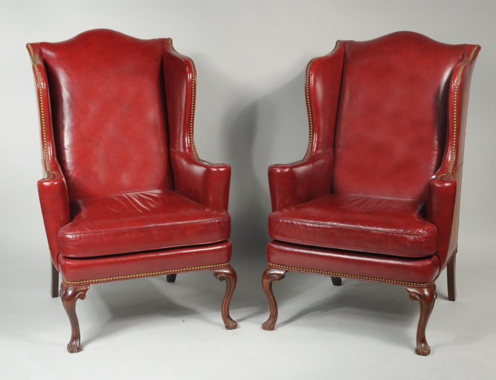 Pair Queen Anne Style Red Leather Wing Chairs: Pair of Queen Anne style red leather wing chairs. 47 1/2" high, 31 1/2" wide, 19 1/2" deep. Condition: use wear, small areas of finish wear, loss to leather, one with repair to left front leg.