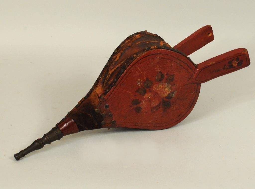 Folk Art Early Painted Bellows: Folk art early painted bellows in red with floral decoration. 17" long, 6 3/4" wide. Condition: crazing, leather tears, losses.
