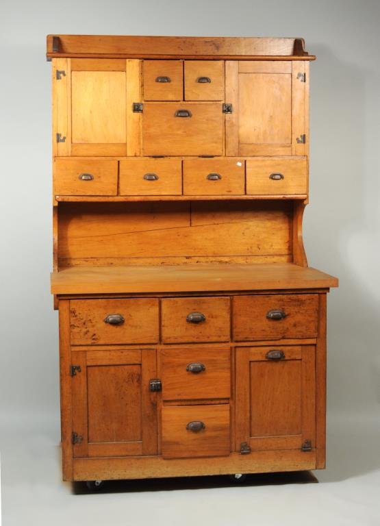 American Butternut Hoosier Cupboard: American butternut Hoosier cupboard/baker's cabinet, top with multiple short drawers flanked by two cupboards, butternut working surface over multiple drawers, one cupboard and flour bin. 77 1/2" high