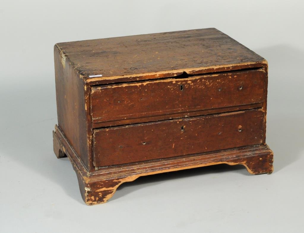 Early Painted Two Drawer Low Chest: Primitive painted Chippendale two drawer low chest, lift top and bracket base. 18 1/2" high, 27 1/2" wide, 19" deep.