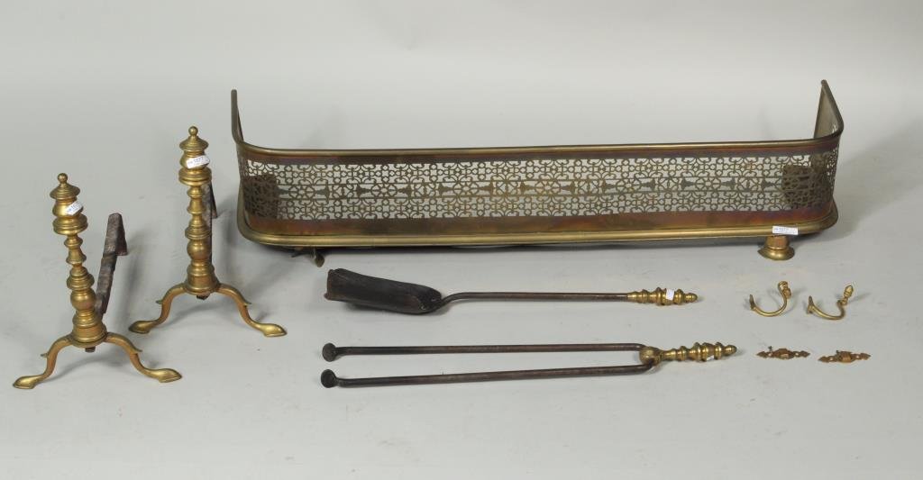 Large Group Brass Fireplace Equipment: Large group mostly brass fireplace equipment, comprising a pair of andirons, pair fire tools (shovel & tongs), a brass fire fender and a pair of brass jamb hooks. Andirons: 14” high. Fire fender 42�