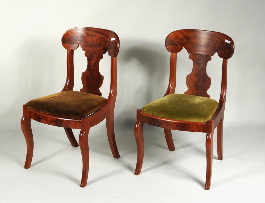 Pair American Empire Mahogany Side Chairs: Pair of American Empire mahogany side chairs, having flame mahogany veneers, baluster splats and sabre legs. 32 1/2" high, 17 1/2" wide, 15" deep. Condition: one chair with replaced corner blocks.