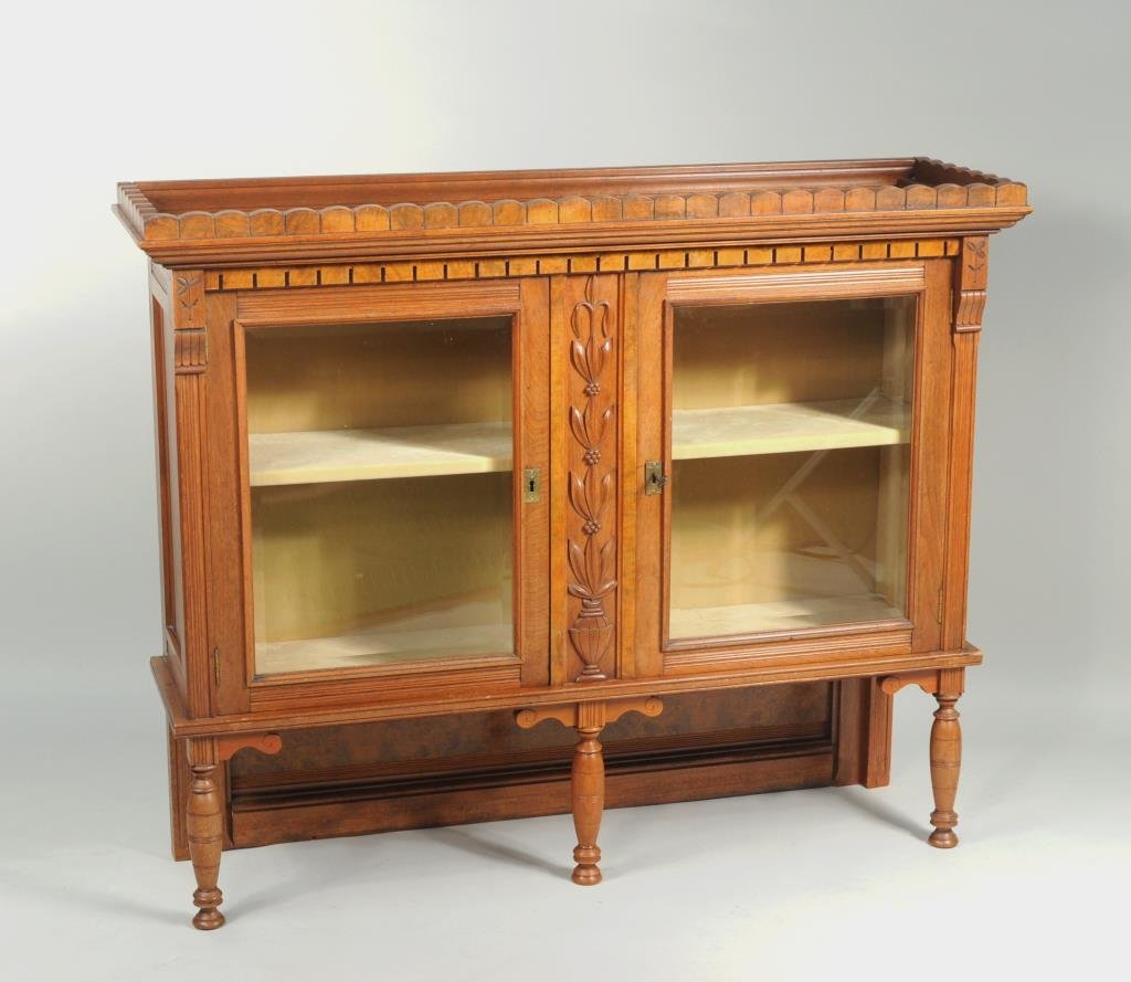 Eastlake China Cupboard: Eastlake China cupboard with two beveled locking glass doors, one interior shelf on turned front supports, with key. 40 3/4" high, 50" wide, 14 1/2" deep. Condition: upper section to two part cabinet,