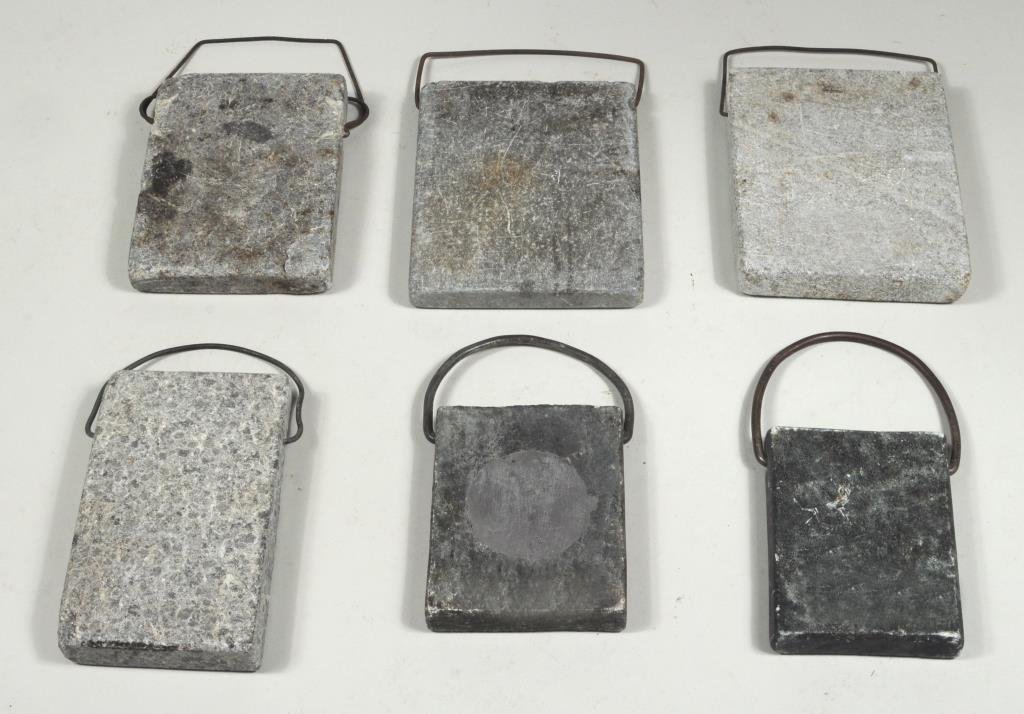 Group Six Stone Warmers W/Wrought Iron Handles: Group of six stone warmers with wrought iron handles including one with lead circle and compass rose engraving. Largest: 10" high, 8" wide. Smallest: 7 1/2" high, 6" wide. Condition: use wear, stains.