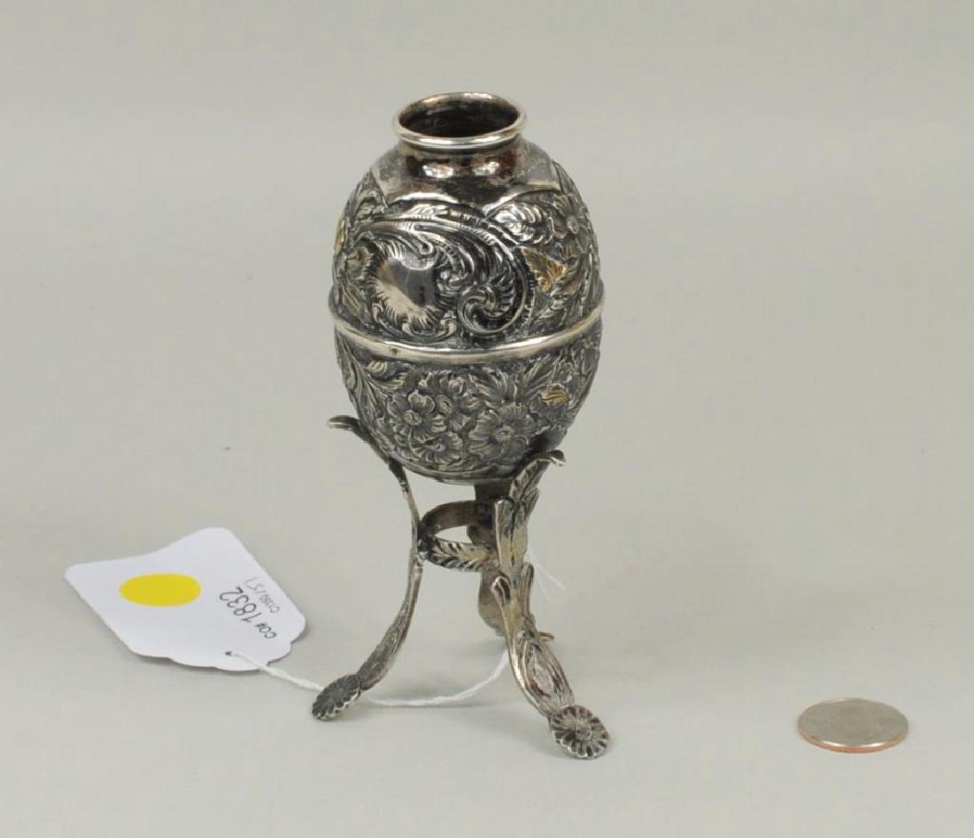 Spanish Colonial .900 Silver & Parcel Gilt Metate: Spanish Colonial .900 silver and parcel gilt metate with repousse floral, foliate decoration. Weight: 4.015 OZT. 5 3/4" high, 2 3/4" wide.