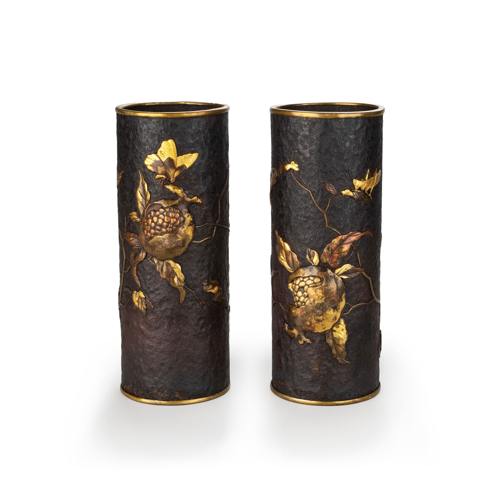 Pair of Iron Vases with Gilded Pomegranate Inlay: This pair of vases is forged from an iron body, preserving throughout the natural hammered texture of the iron surface. The material conveys a sense of weight and strength, fully expressing the rustic