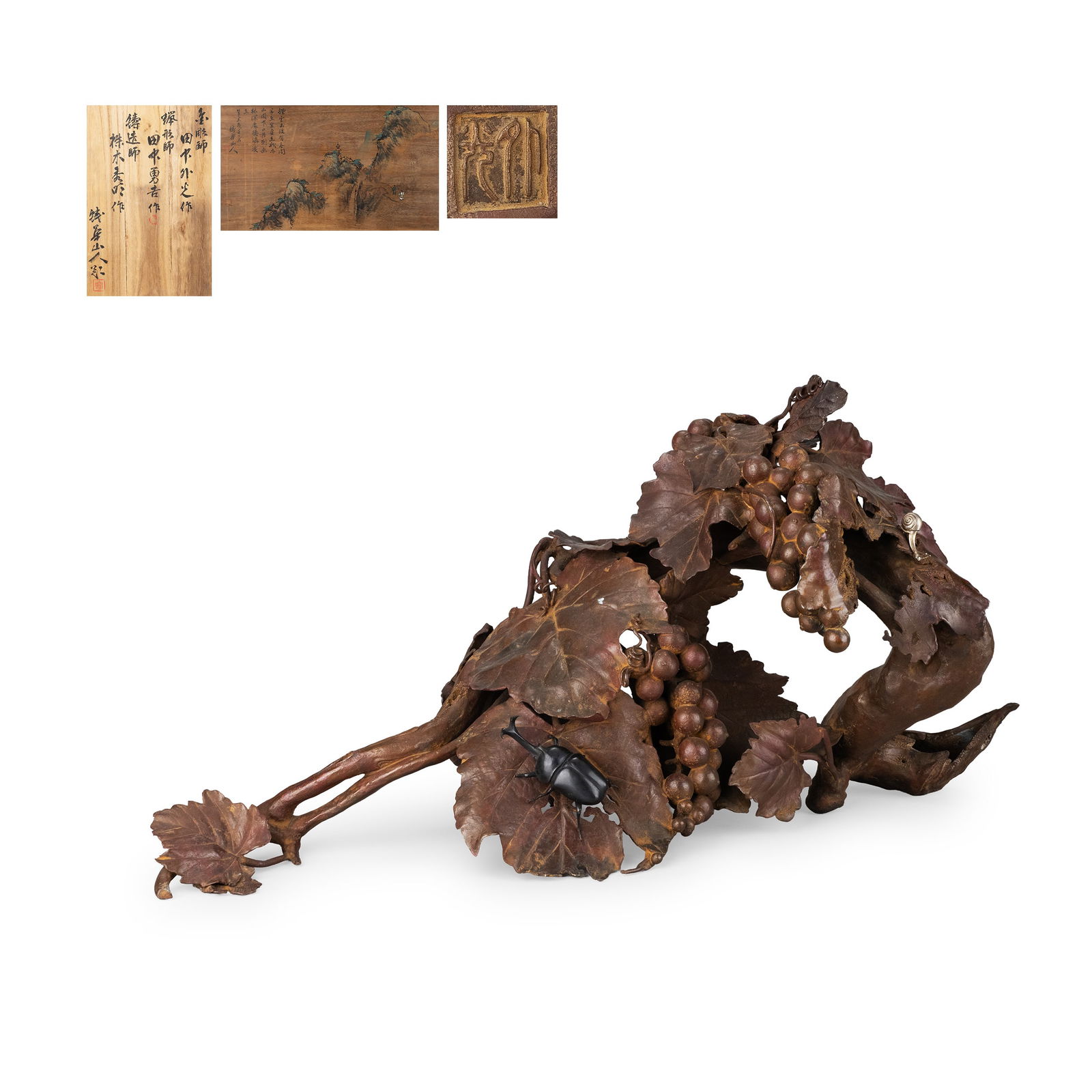 Ornament,Authenticated Box by Tekkasanjin: The composition presents cascading grape clusters and broad leaves arranged along a naturalistic branch form. The modeling of the veins and fruit is carefully articulated, while the fired shudo surfac