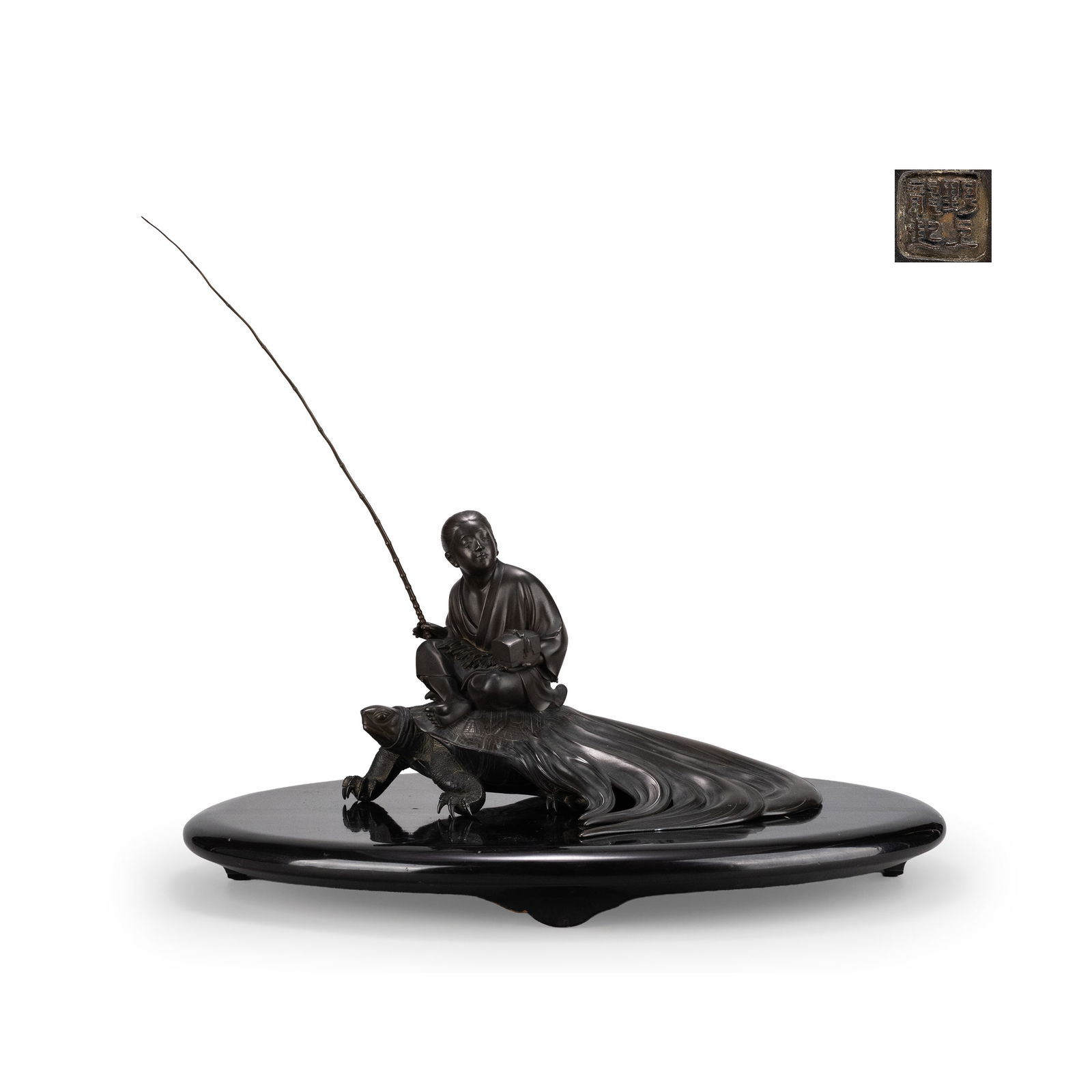 Copper Ornament by Nogami Ry?ki: A finely cast bronze okimono depicting Urashima Taro seated upon a turtle, rendered with refined modeling and controlled patination. The youthful fisherman holds a fishing rod in one hand and a tamate