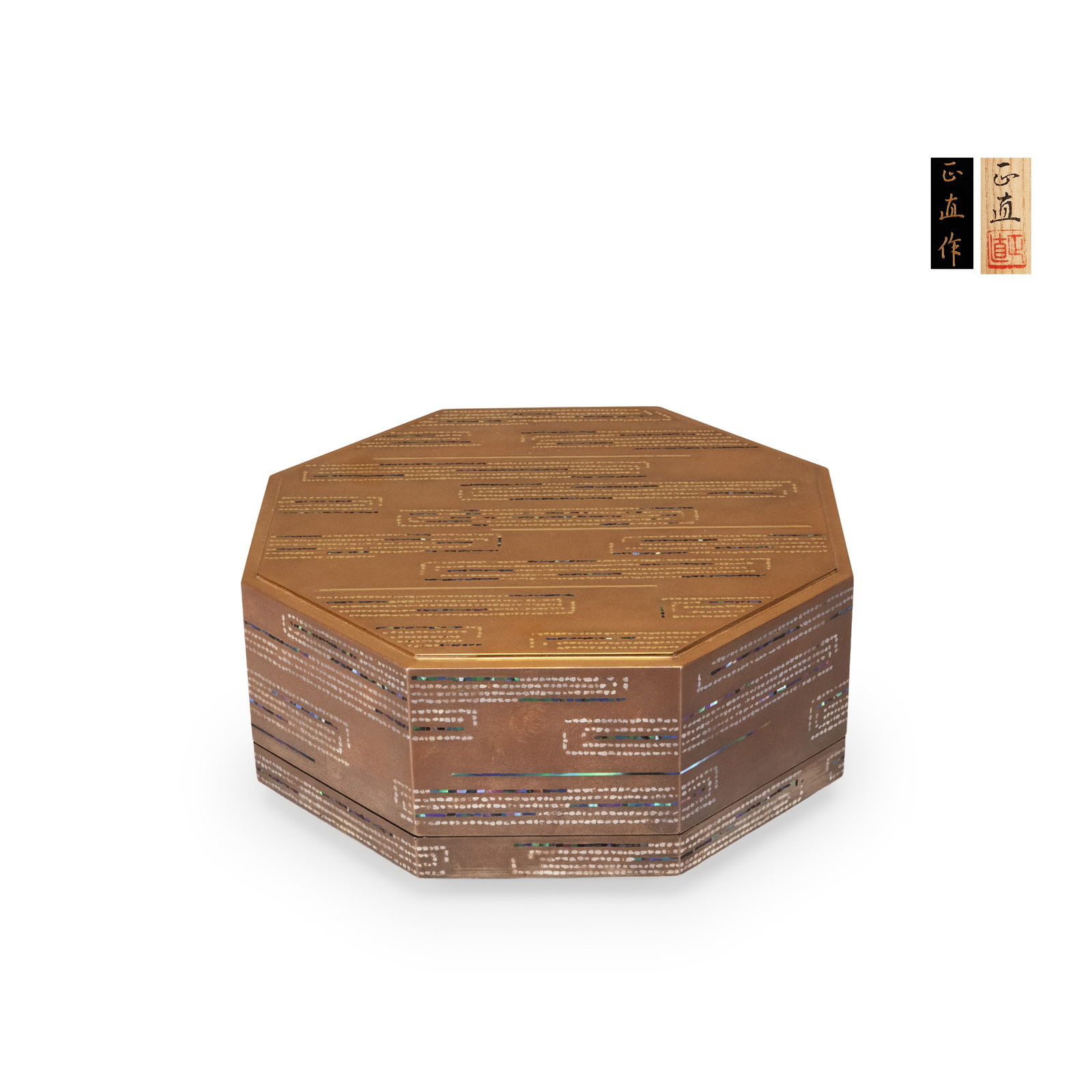 Maki-e Octagonal Box by Naomasa: This box is formed in a well-proportioned octagonal lidded structure. The entire surface is finished in a warm brown-gold lacquer ground, with maki-e decoration applied to both the exterior walls and