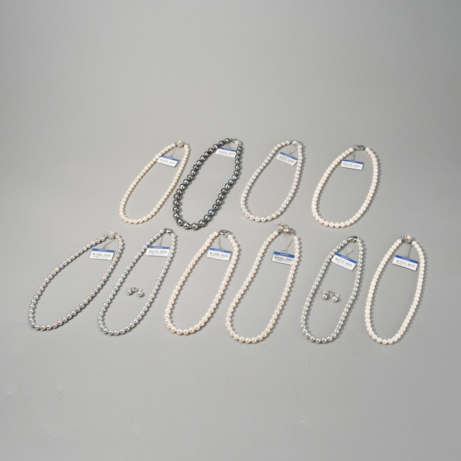 Ten pearl necklaces: This lot comprises ten pearl necklaces offered together as a group. The pearls display a range of tones, including white, cream, and grey, with each necklace formed from a continuous strand of pearls.