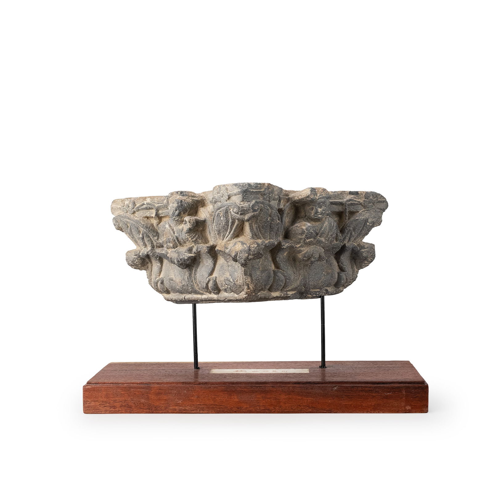 Gandhara Sculpture with Certificate by Kurita Isao: Carved in grey schist, this architectural capital fragment features a central seated figure framed by luxuriant acanthus leaves and flanked by attendant figures. The composition is arranged symmetrica