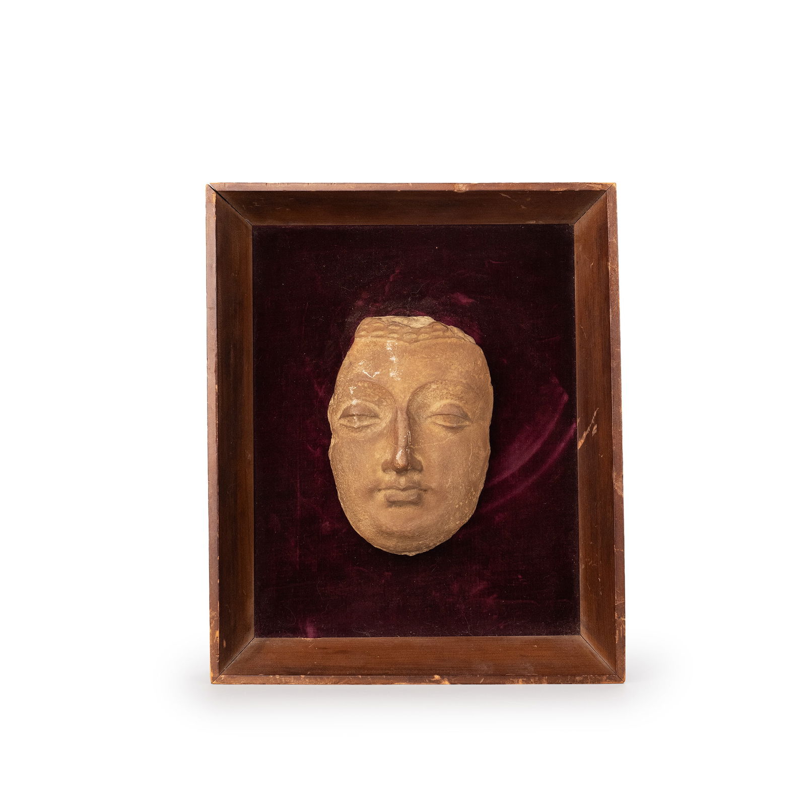 Indian Hadda Buddha Head Relief: This piece is a fragmentary stone Buddhist sculpture from India, representing the head of a Buddha image. The face is composed with dignity and serenity, showing balanced proportions, a broad forehead