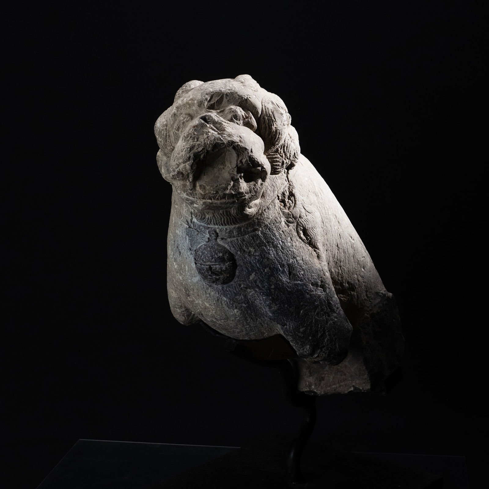 Stone Lion Ornament: Carved from stone, this sculptural lion displays a substantial, compact form with a weathered grey surface, emphasizing its age and material presence. The expressive face features an open mouth and st