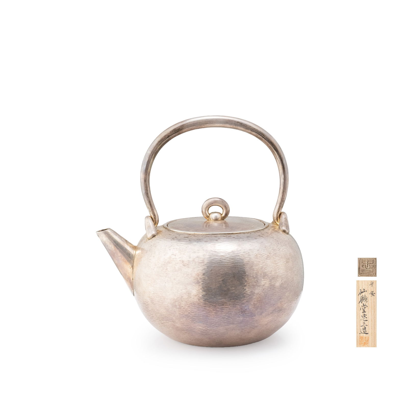 Sterling Silver Kettle by Senkakudo Chuzo, Box: A pure silver kettle by Senkakud? Ch?z?, worked entirely in a finely executed kasumi-tsuchime [mist-like hammered] surface. The body is of rounded form with a stable, low-centered profile. The