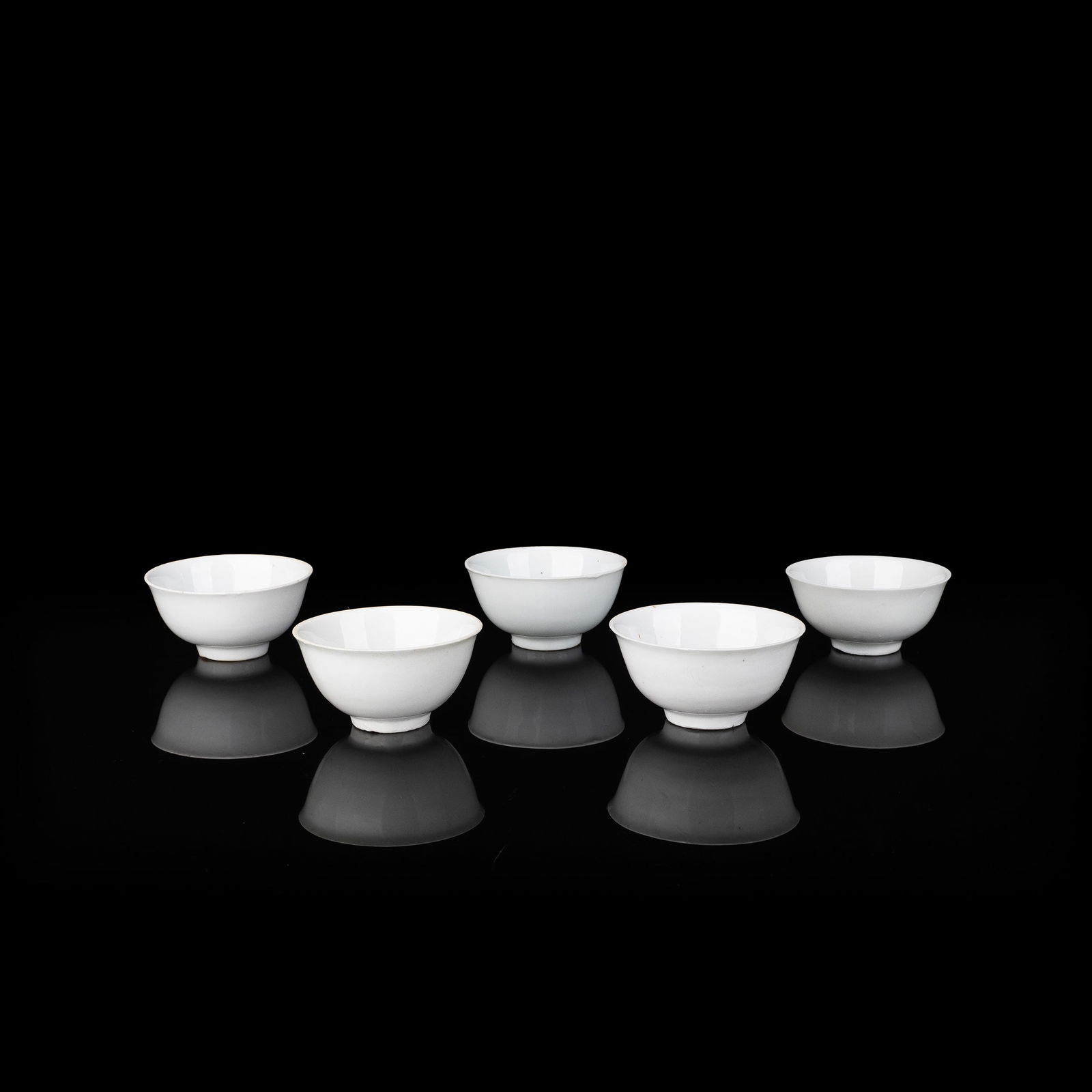 Set of 5 Dehua White Porcelain Sencha Cups: This set comprises five white porcelain sencha cups. The bodies are covered in a lustrous white glaze of refined purity, exhibiting a delicate texture and a soft, restrained sheen. The porcelain