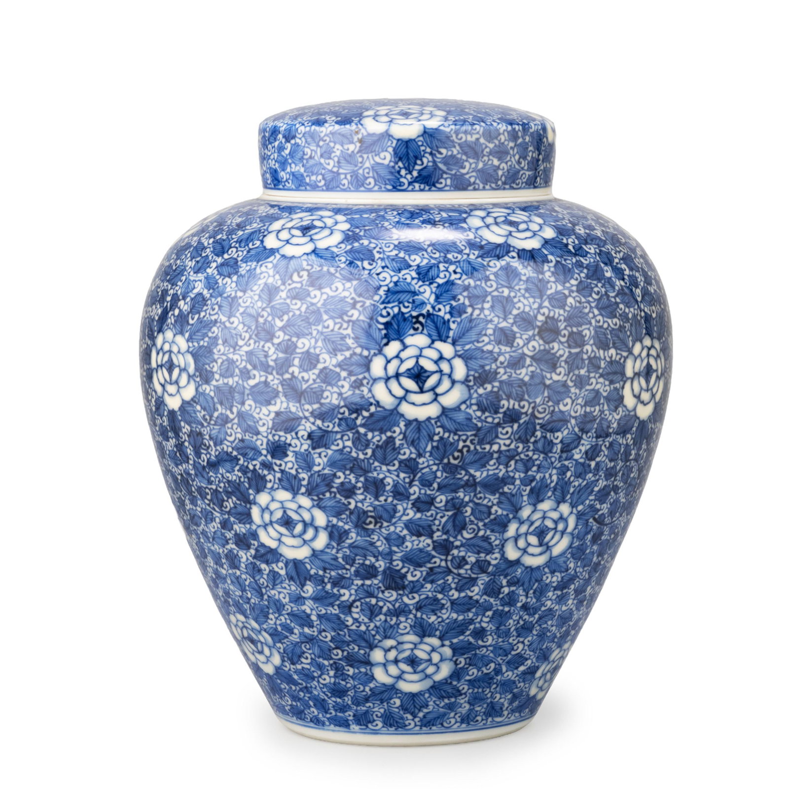Seto Ware Covered Jar by Kato Shigeju: Richly decorated in underglaze blue with an all-over scrolling floral design. Stylized blossoms reserved in white emerge rhythmically from a dense network of intertwining foliage, creating an elegant 