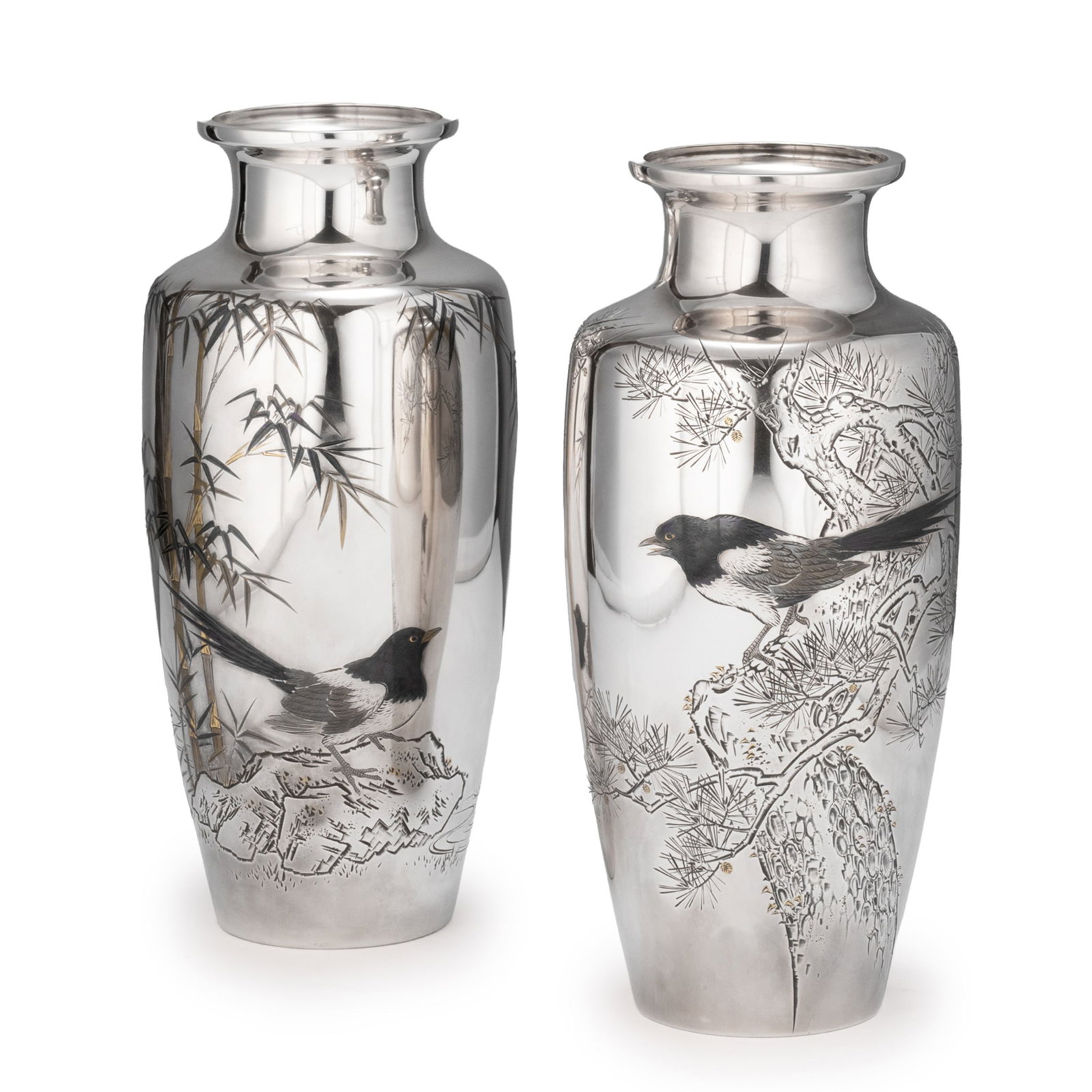 Pair of Pure Silver Vases by Toshu: Against the mirror-polished surface of pure silver, scenes of pine, bamboo, and magpies unfold across a spacious pictorial field. Broad areas of untouched silver create an elegant sense of openness, w