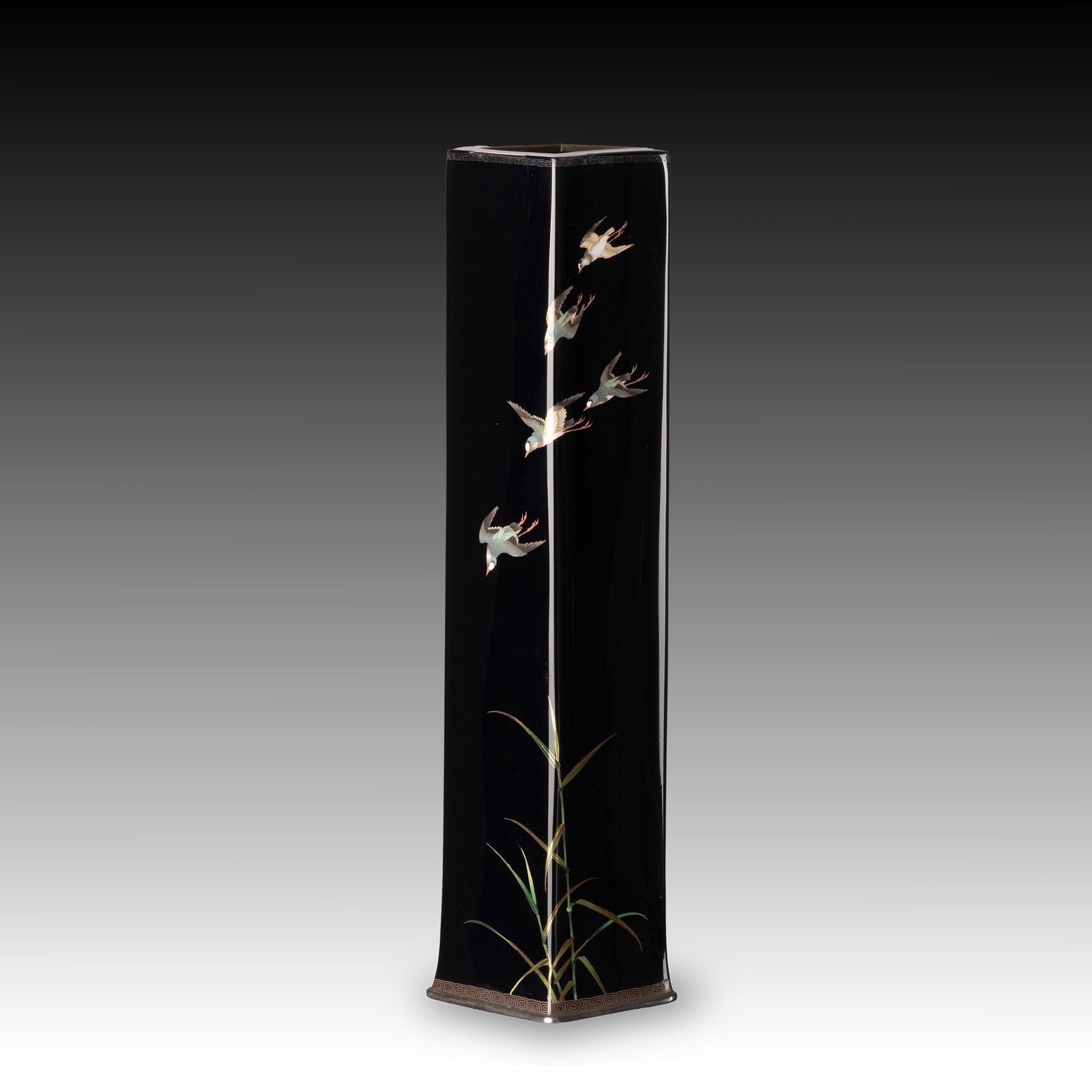 Cloisonne Vase: This elegant Japanese cloisonne enamel vase is of tall square-section form, rising from a gently flared foot to a square mouth. The restrained architectural silhouette is enhanced by key-fret borders 