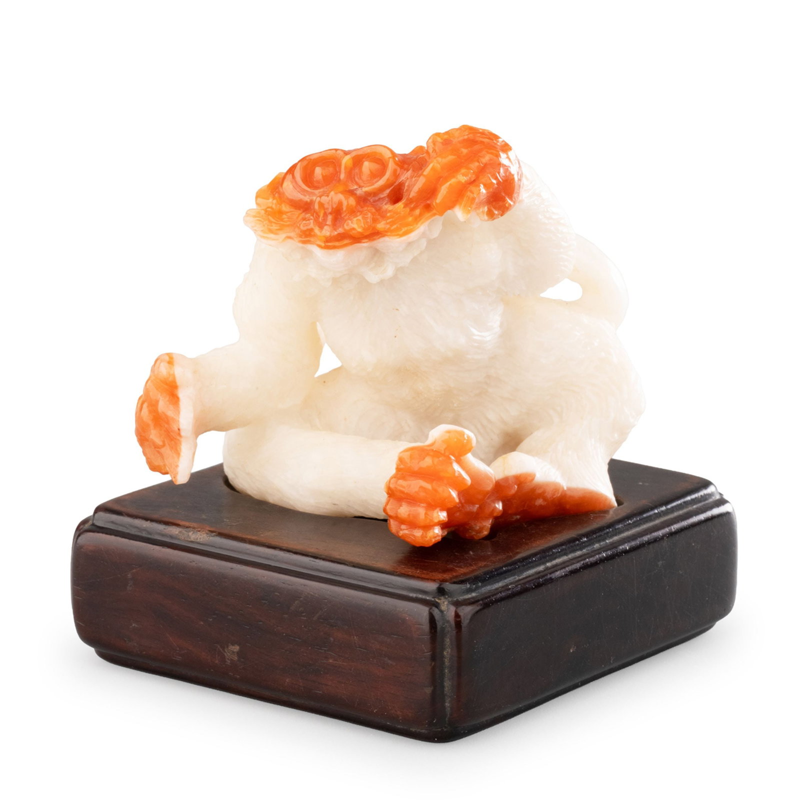 Agate Monkey Figure: This charming monkey figure is carved from natural agate, skillfully utilizing the stone's contrasting red and white coloration. The sculptor has employed the vivid reddish layer for the monkey's face