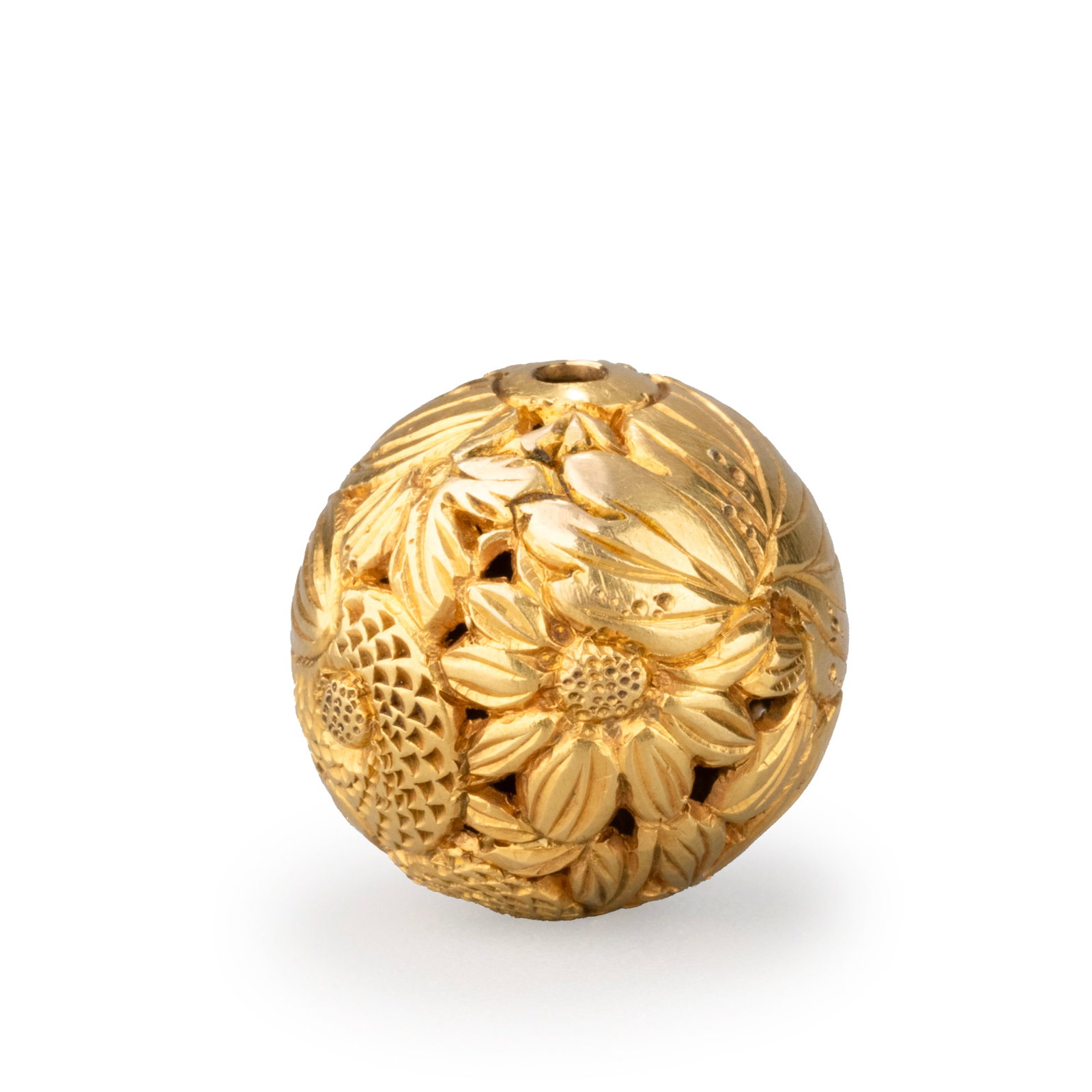 Gold Ojime: Decorated in openwork and high relief with an intricate floral design featuring chrysanthemums, bamboo leaves, and scrolling foliage. The richly layered composition demonstrates refined Japanese metal