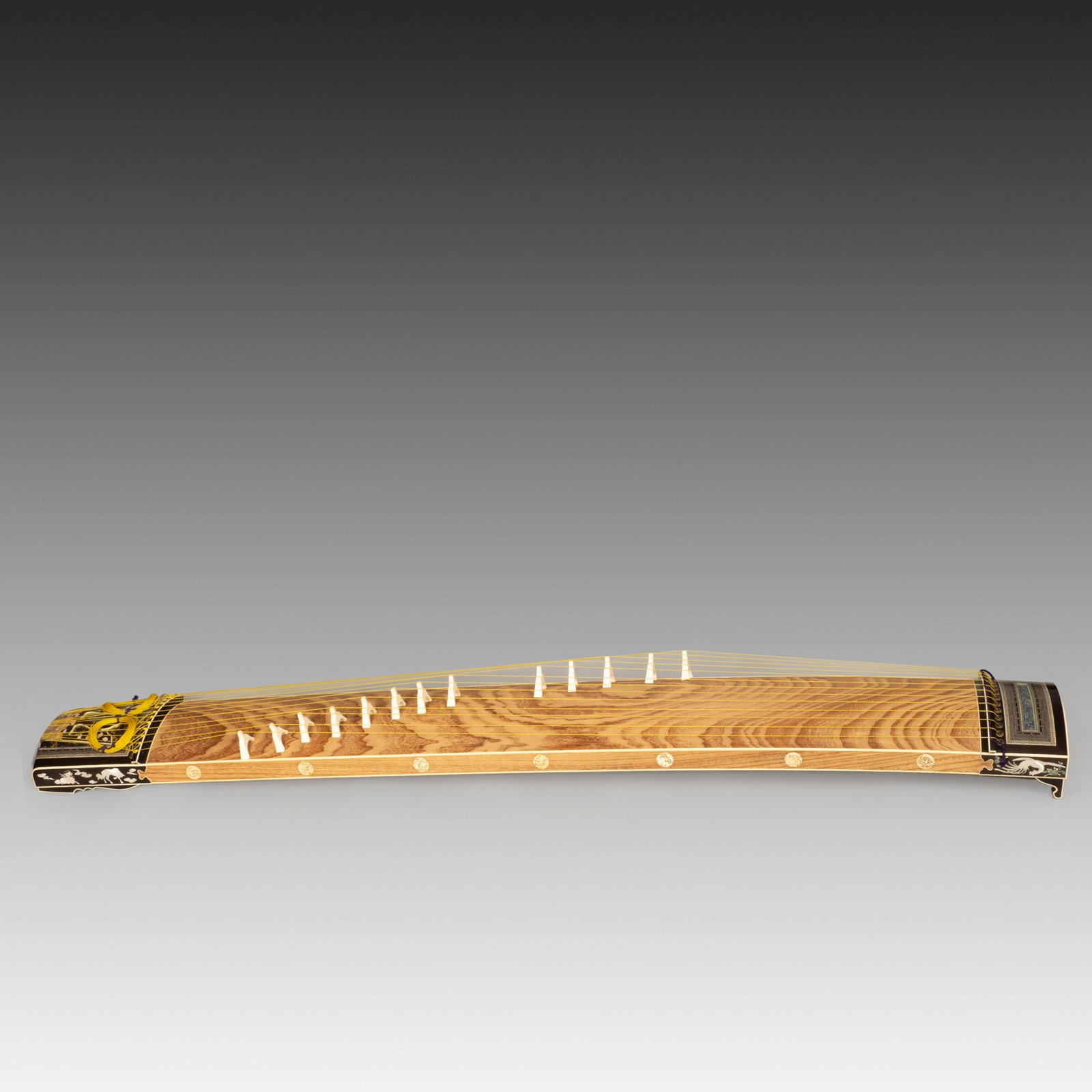 Shibayama Inlaid Thirteen String Koto: Richly decorated with silver and Shibayama-style inlay, demonstrating the refined craftsmanship of traditional Japanese musical instruments.The body is formed from beautifully figured wood, accentuate