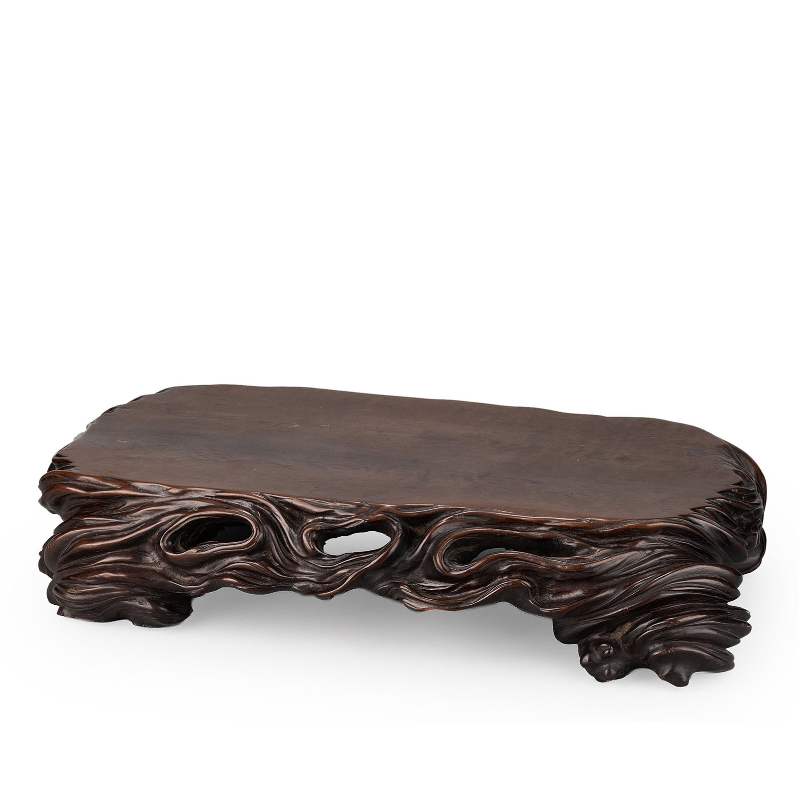 Natural Wood Stand: Carved from a single section of natural wood, this display stand features a broad, flat top while preserving the organic contours of the material. The edges are skillfully shaped to follow the natural