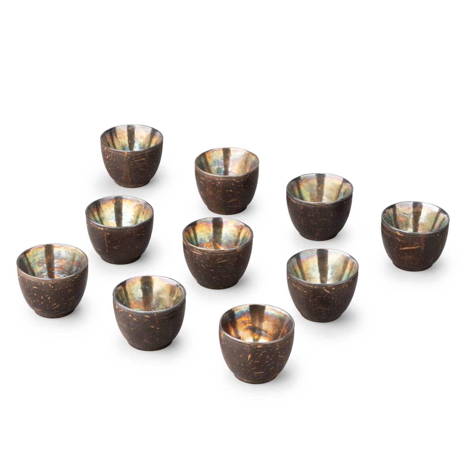 Set of Ten Silver Mounted Coconut Shell Cups: This attractive set of ten drinking cups is crafted from natural coconut shells fitted with silver liners, combining organic materials with refined silversmithing. The harmonious contrast between the 